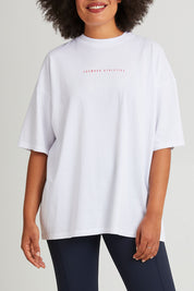 Model Olivia wearing size 10 of the Leisure Captain Cotton Tee in colour White (White), from the front, cropped image