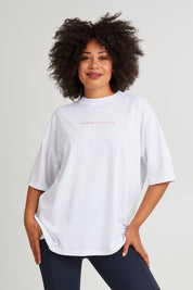 Model Olivia wearing size 10 of the Leisure Captain Cotton Tee in colour White (White), from the front, cropped image