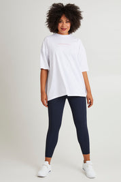 Model Olivia wearing size 10 of the Leisure Captain Cotton Tee in colour White (White), from the front, showing the whole outfit
