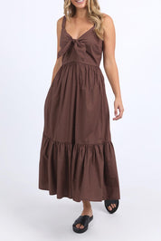A model wearing the Esmerelda Cotton Dress in colour Chocolate, from the front, cropped image