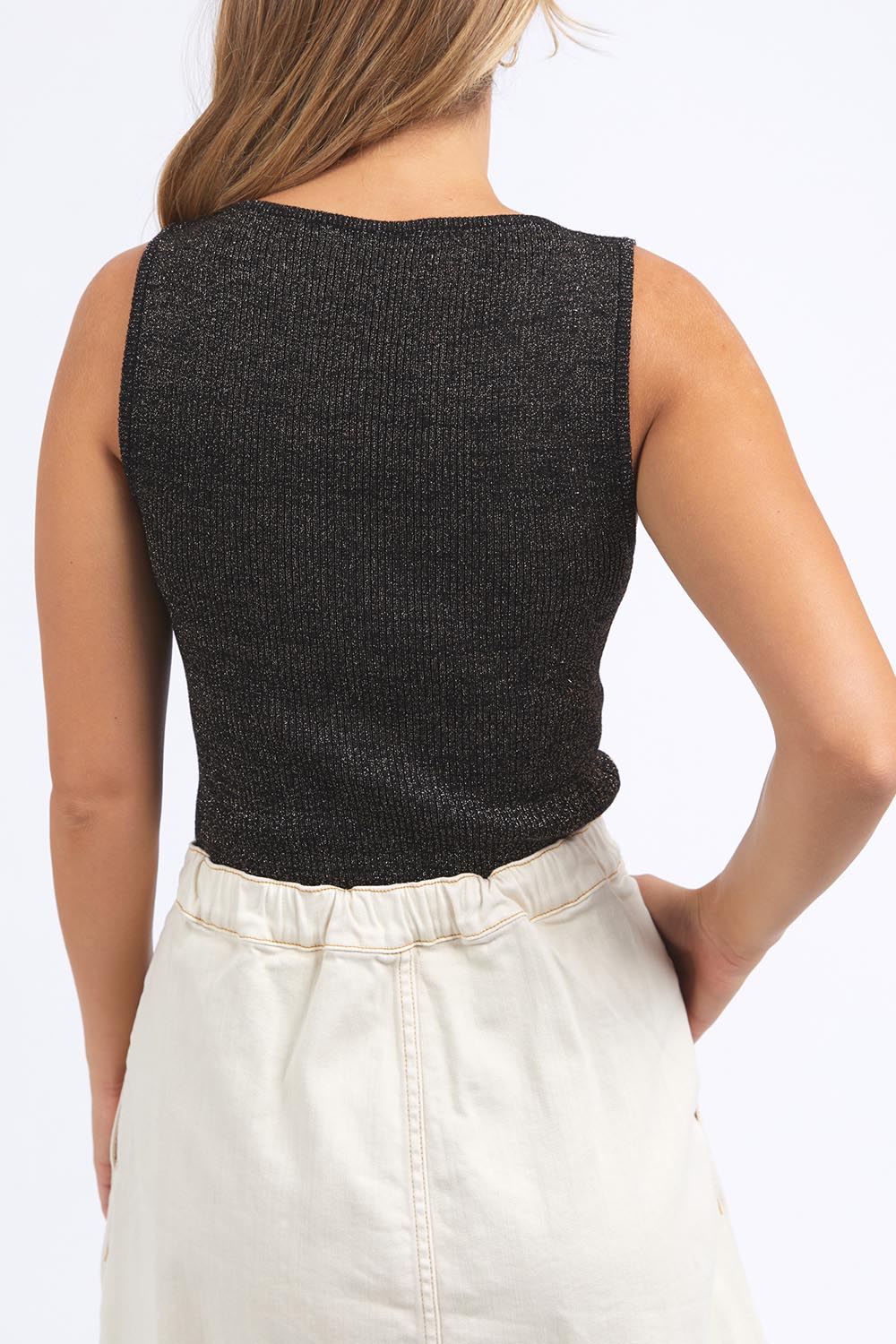 A model wearing the Tessa Metallic Knit Tank in colour Black (Black), from the back
