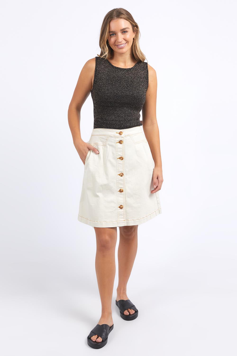 A model wearing the Tessa Metallic Knit Tank in colour Black (Black), from the front, showing the whole outfit