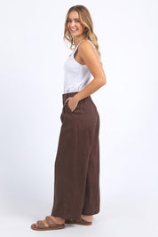 A model wearing the Pierra Linen Pant in colour Chocolate, from the front, showing the whole outfit