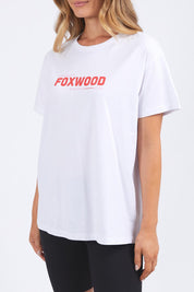 A model wearing the Leisure Overload Cotton Tee in colour White (White), from the front, cropped image
