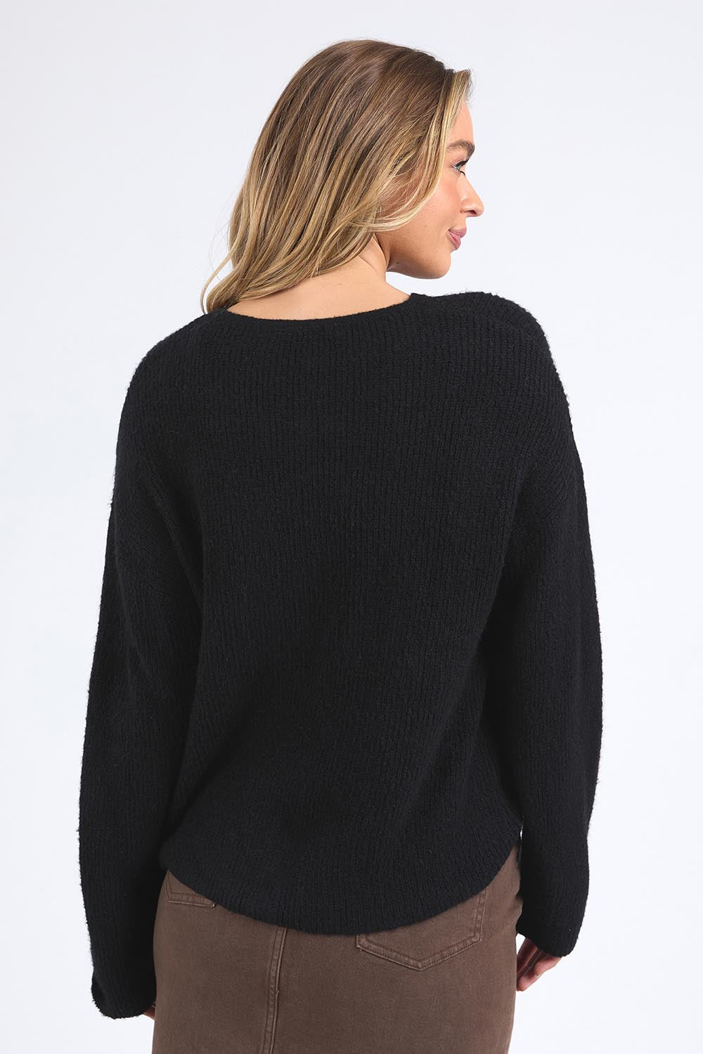 A model wearing the Murphy Knit Cardigan in colour Black (Black), from the back