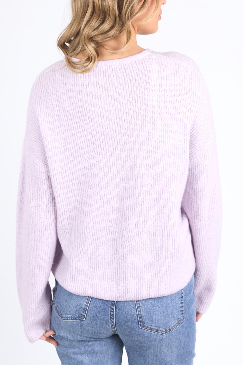 A model wearing the Murphy Knit Cardigan in colour Orchid (Purple), from the back