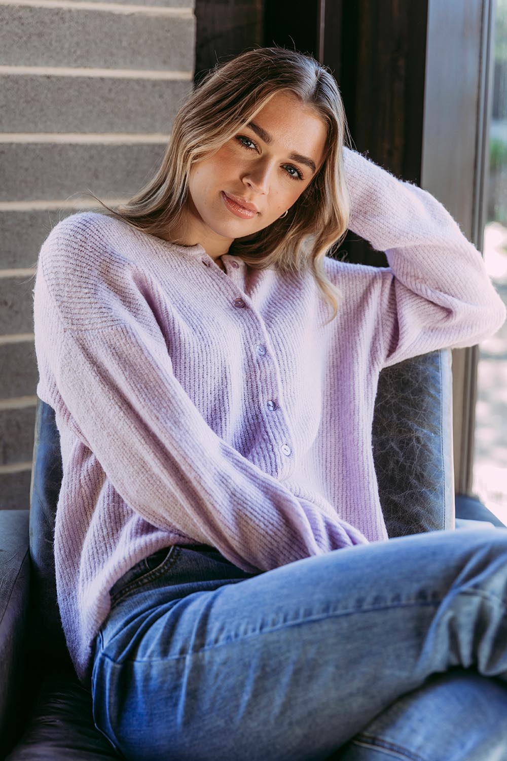 A model wearing the Murphy Knit Cardigan in colour Orchid (Purple), from the front, showing the whole outfit