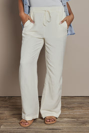 Model Ziara wearing size 10 of the South Linen Blend Pant in colour Vinwhite (White), from the front, cropped image