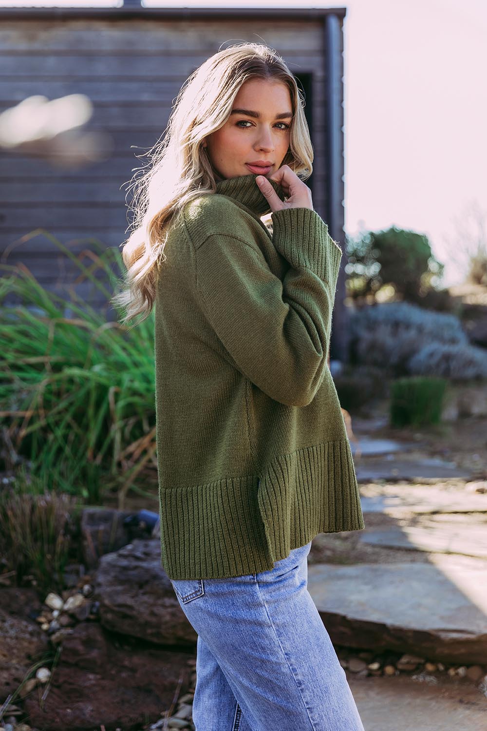 A model wearing the Jude Wool Blend Knit in colour Olivegree (Green), from the front, showing the whole outfit