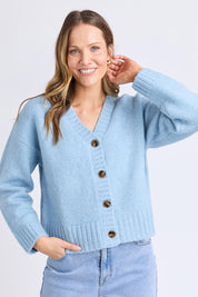 A model wearing the Jensen Button Cardi in colour Celestialb (Blue), from the front, cropped image