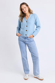A model wearing the Jensen Button Cardi in colour Celestialb (Blue), from the front, showing the whole outfit