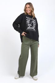 A model wearing the Happiness Cotton Crew in colour Washblack (Black), from the front, showing the whole outfit
