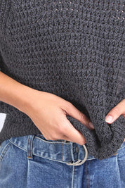 A model wearing the Isla Knit Vest in colour Charcoal (Black), from the front, cropped image