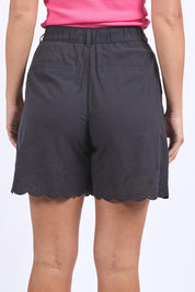 A model wearing the Madeline Short in colour Black (Black), from the back