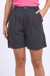 A model wearing the Madeline Short in colour Black (Black), from the front, cropped image