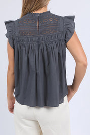 A model wearing the Adelyn Cotton Top in colour Charcoal (Grey), from the back