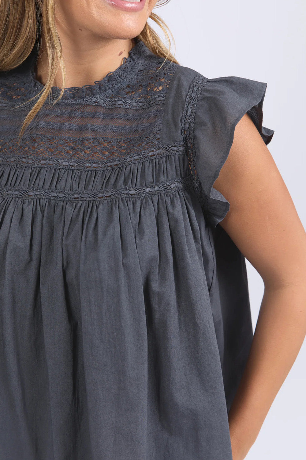 A model wearing the Adelyn Cotton Top in colour Charcoal (Grey), from the front, cropped image