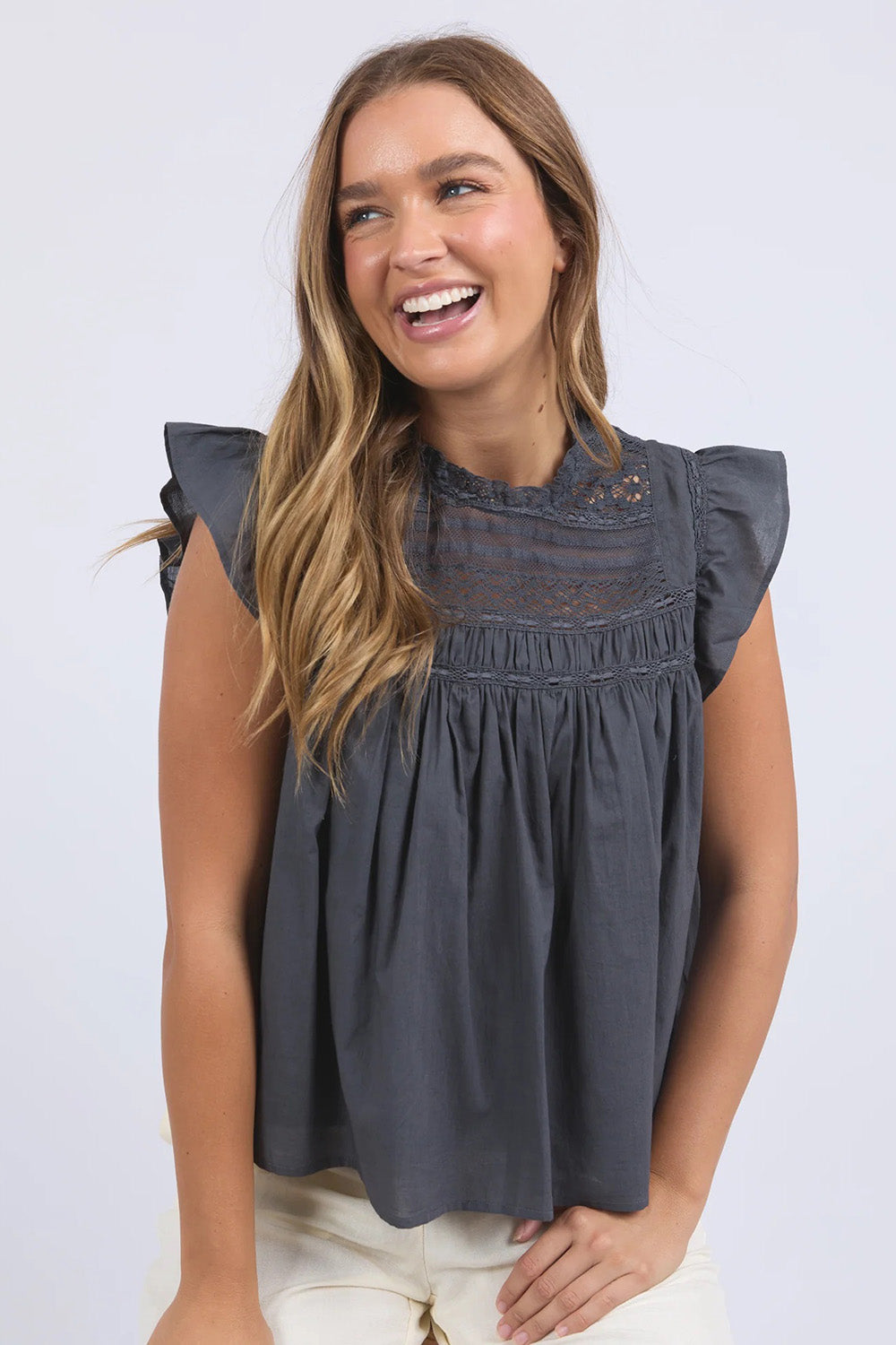 A model wearing the Adelyn Cotton Top in colour Charcoal (Grey), from the front, showing the whole outfit