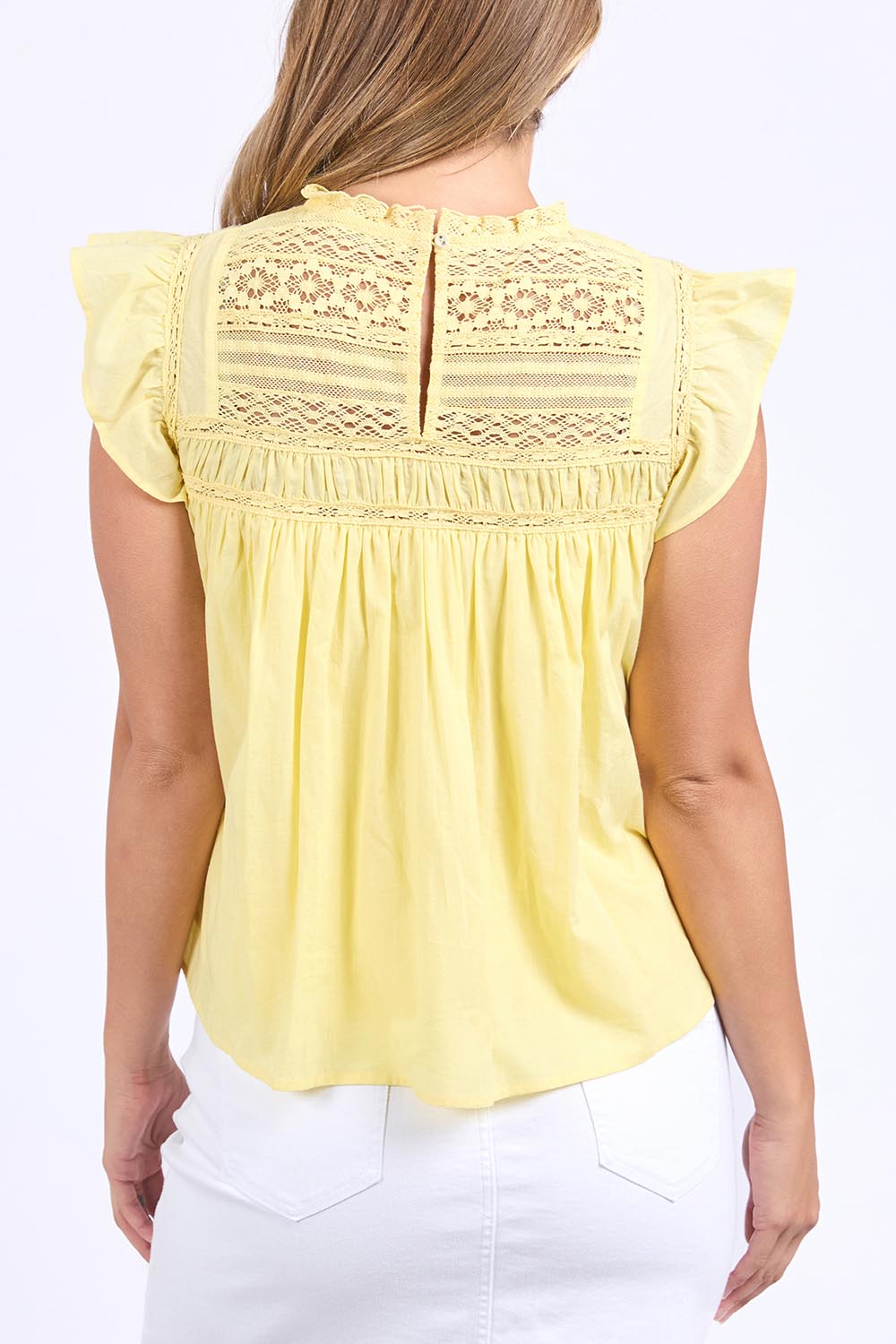A model wearing the Adelyn Cotton Top in colour Lemon, from the back
