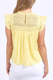 A model wearing the Adelyn Cotton Top in colour Lemon, from the back
