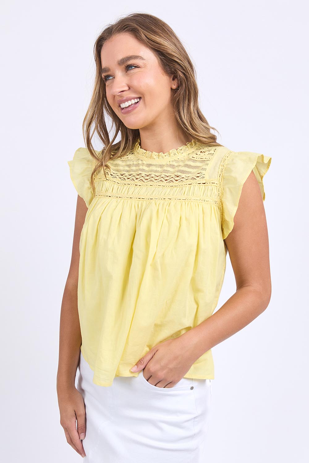A model wearing the Adelyn Cotton Top in colour Lemon, from the front, cropped image