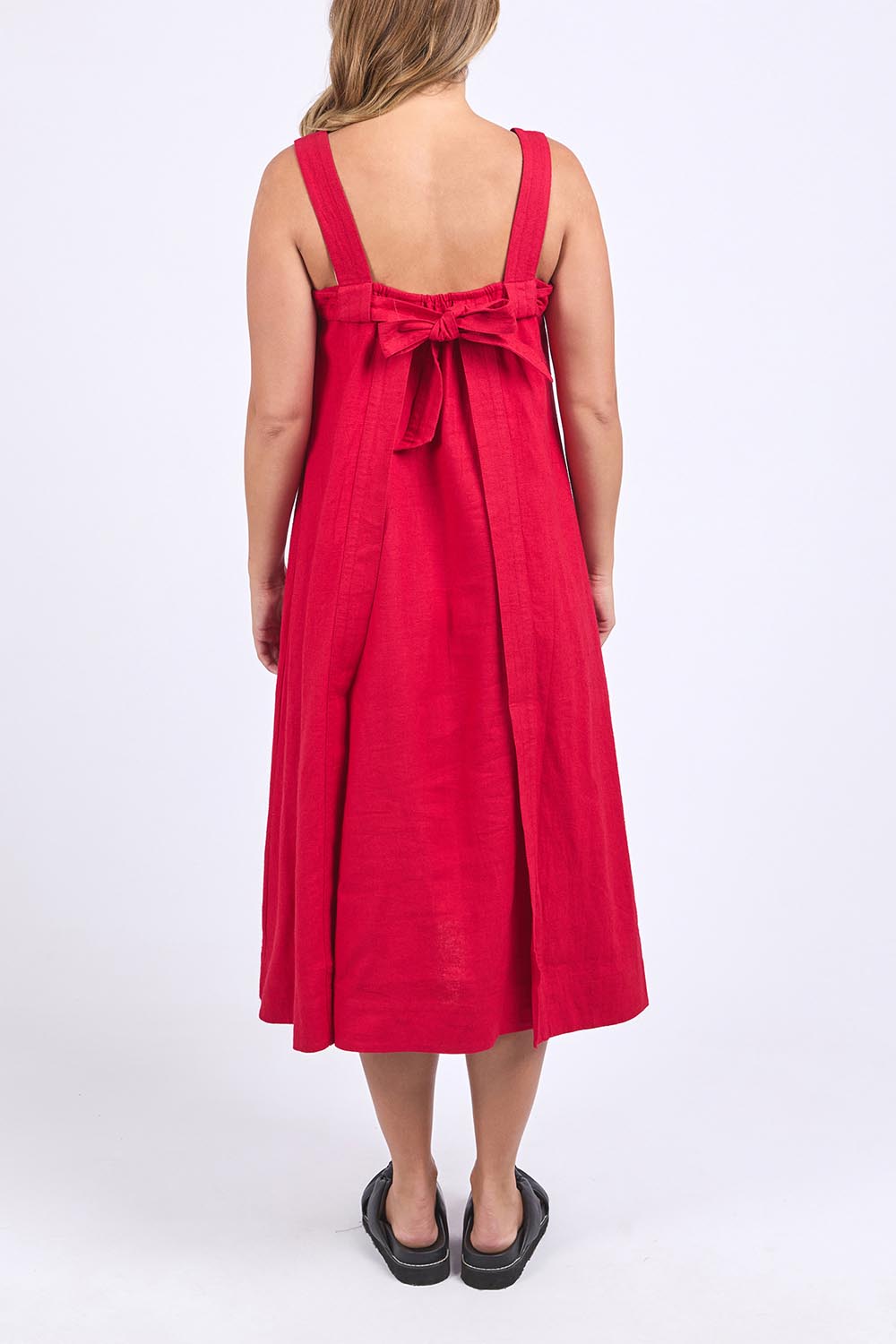 A model wearing the Lourdes Linen Blend Dress in colour Crimson (Red), from the back