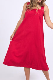 A model wearing the Lourdes Linen Blend Dress in colour Crimson (Red), from the front, cropped image
