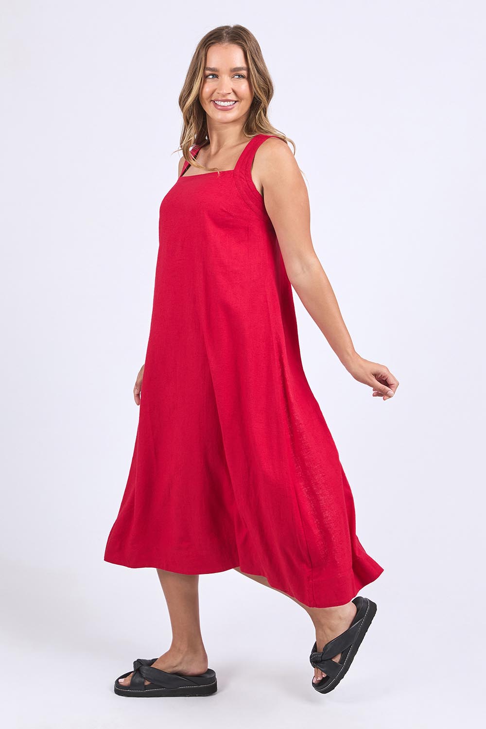 A model wearing the Lourdes Linen Blend Dress in colour Crimson (Red), from the front, showing the whole outfit