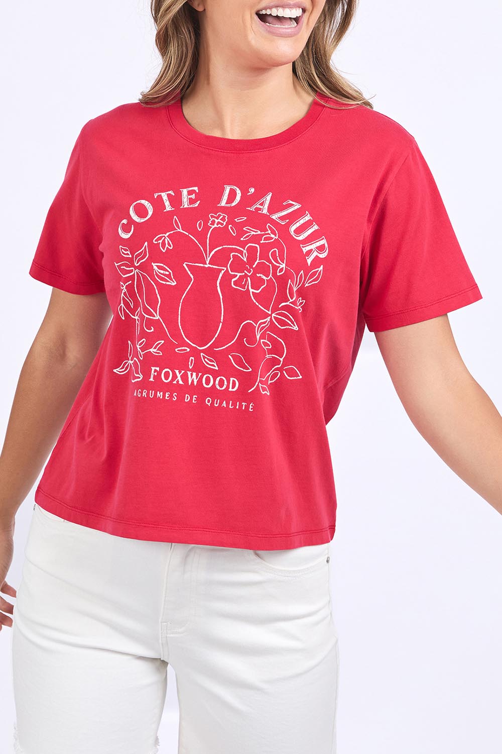 A model wearing the Cote D'azur Cotton Tee in colour Crimson (Red), from the front, cropped image