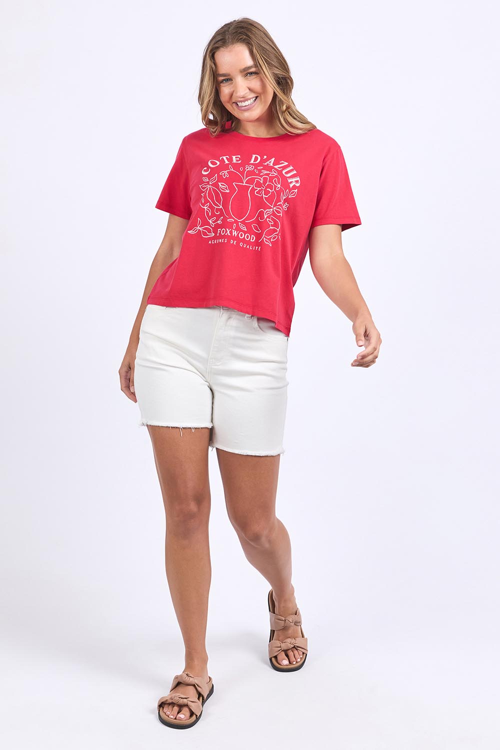 A model wearing the Cote D'azur Cotton Tee in colour Crimson (Red), from the front, showing the whole outfit