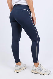 A model wearing the Elements Piping Leggings in colour Navy (Blue), from the back