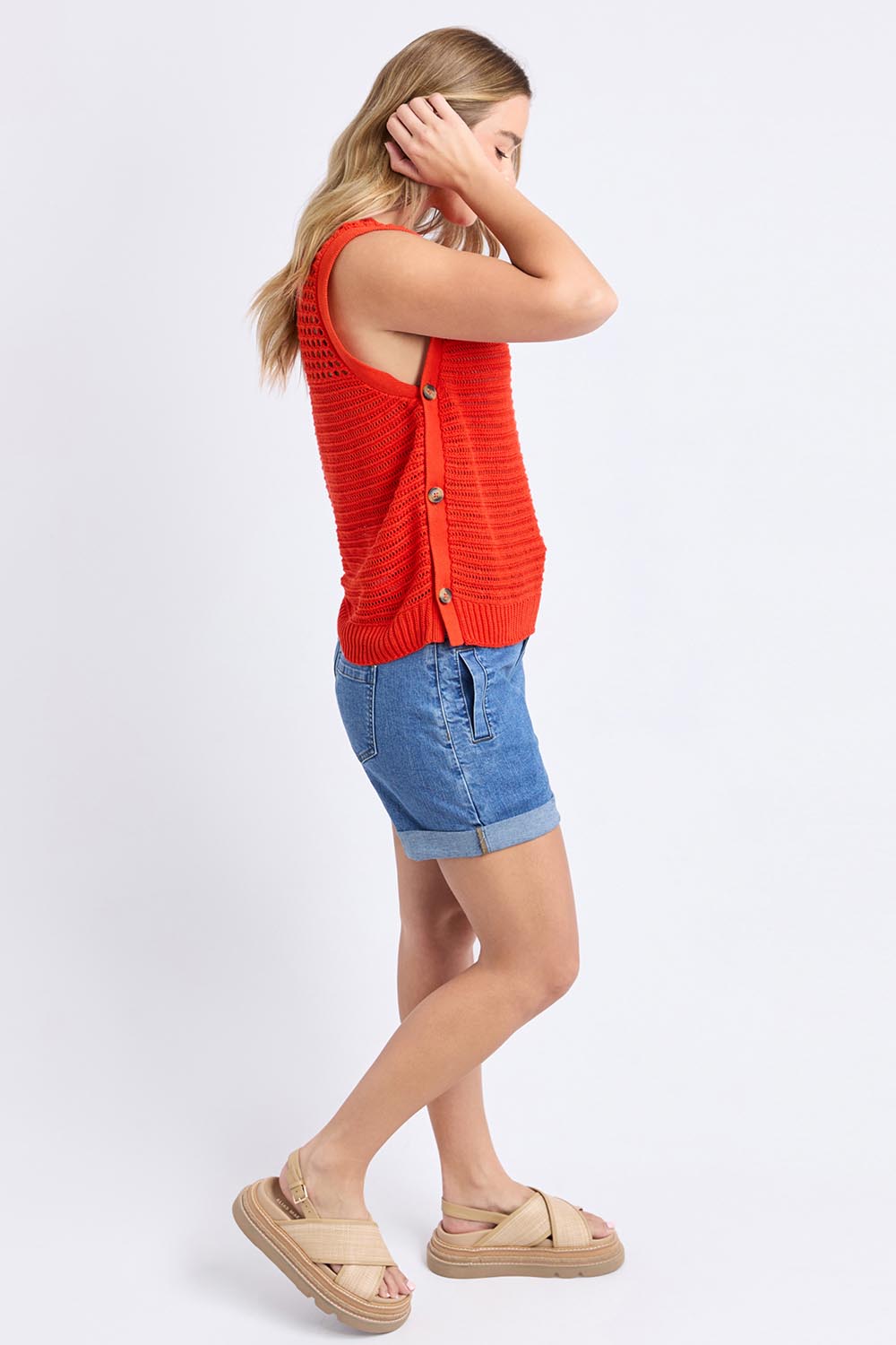 A model wearing the Chilli Cotton Knit Top in colour Tangelo, from the front, showing the whole outfit