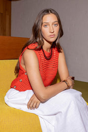 A model wearing the Chilli Cotton Knit Top in colour Tangelo, from the front, showing the whole outfit