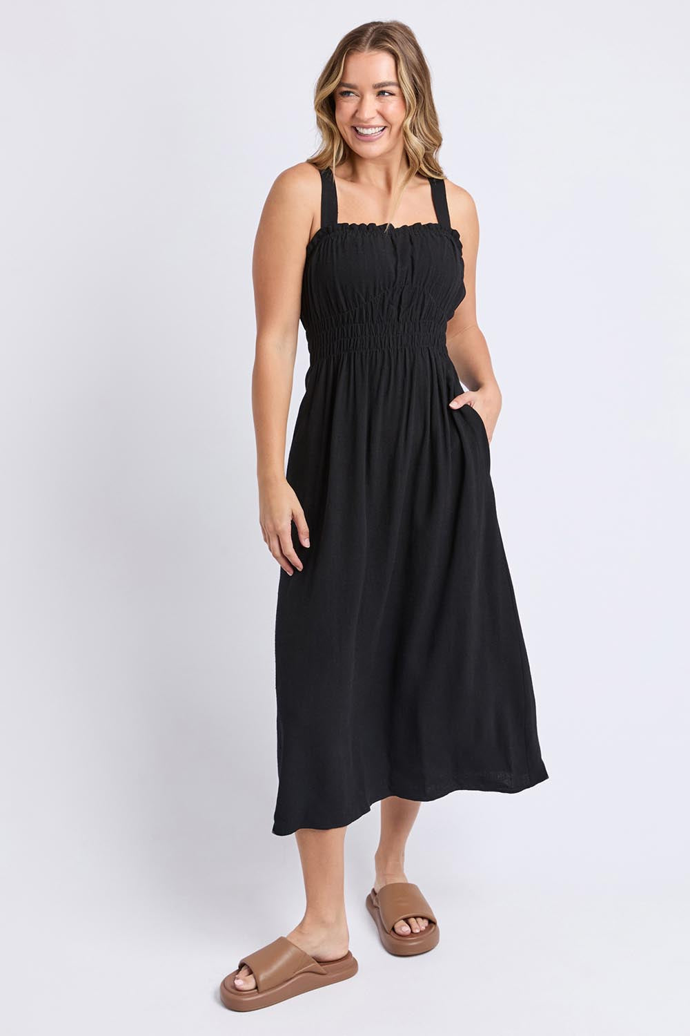 A model wearing the Dandelion Cotton Blend Dress in colour Black (Black), from the front, showing the whole outfit