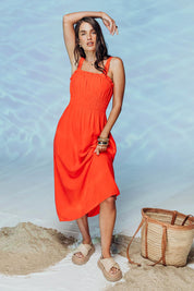 A model wearing the Dandelion Cotton Blend Dress in colour Tangelo, from the front, showing the whole outfit