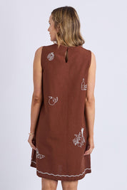 A model wearing the Paradise Cotton Linen Dress in colour Chocolate, from the back