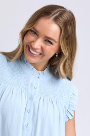 A model wearing the Airlie Cotton Blend Top in colour Crystalblu (Blue), from the front, cropped image
