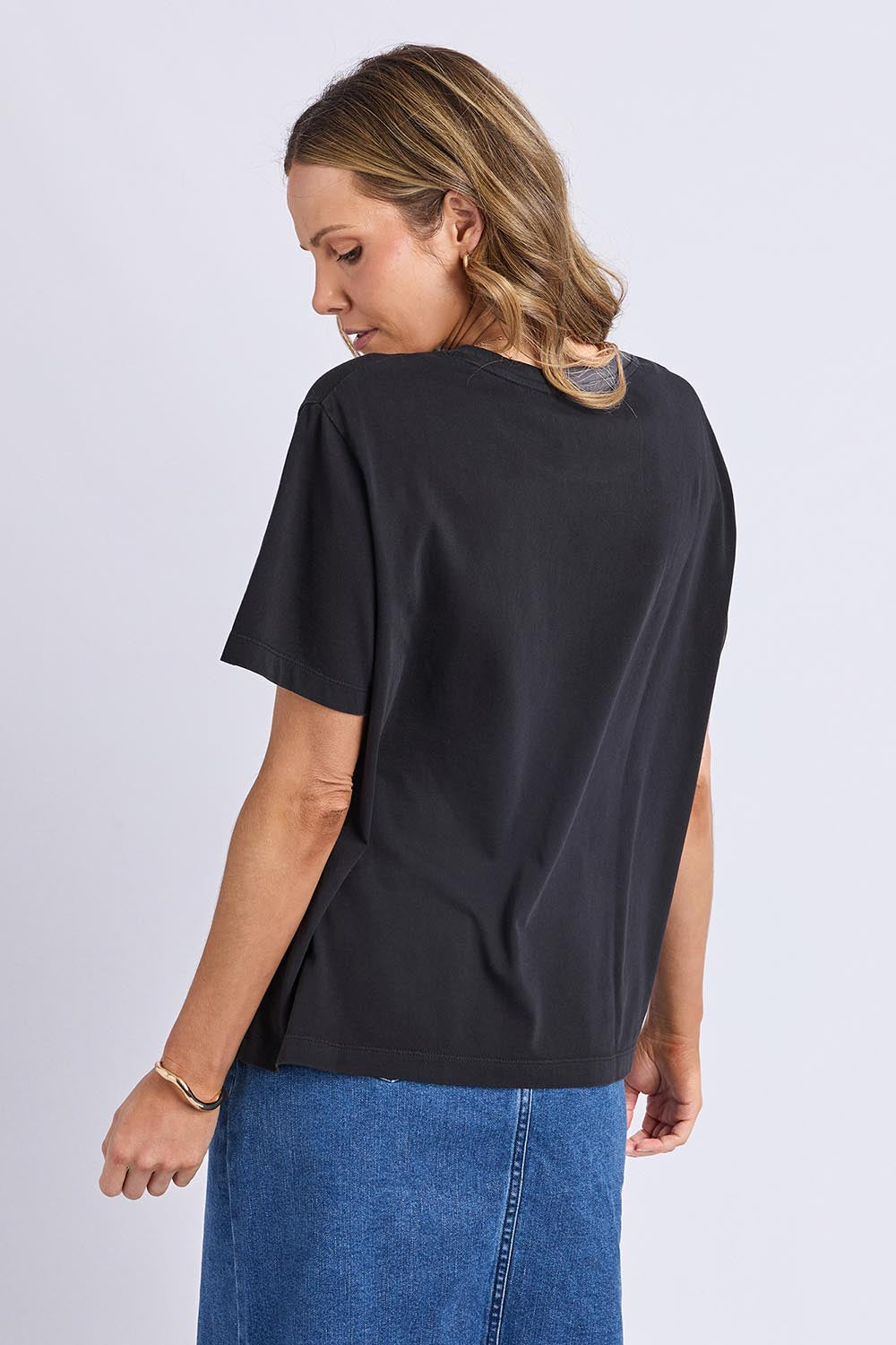 A model wearing the Arancia Cotton Tee in colour Wshedblk (Black), from the back