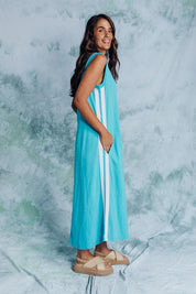 A model wearing the Recovery Cotton Tank Dress in colour Sky (Blue), from the front, showing the whole outfit