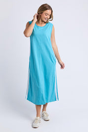A model wearing the Recovery Cotton Tank Dress in colour Sky (Blue), from the front, showing the whole outfit