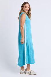 A model wearing the Recovery Cotton Tank Dress in colour Sky (Blue), from the front, showing the whole outfit