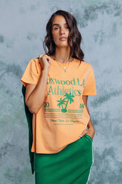 A model wearing the LA Aths Cotton Tee in colour Peach, from the front, showing the whole outfit