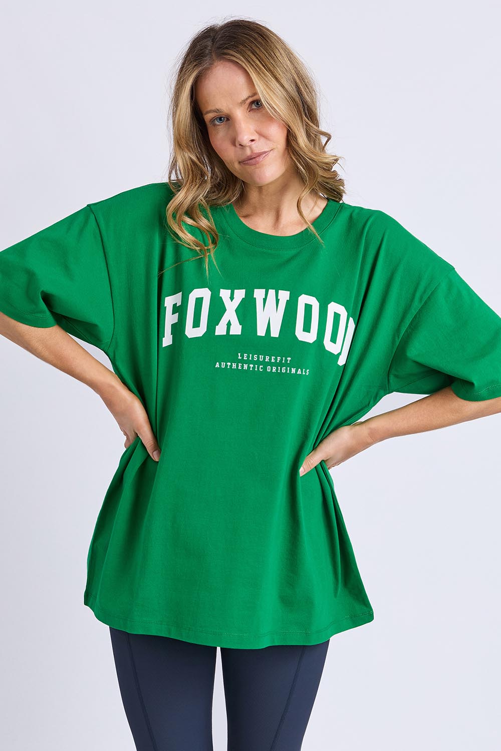 A model wearing the Interval Cotton Tee in colour Green (Green), from the front, cropped image