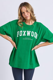 A model wearing the Interval Cotton Tee in colour Green (Green), from the front, cropped image