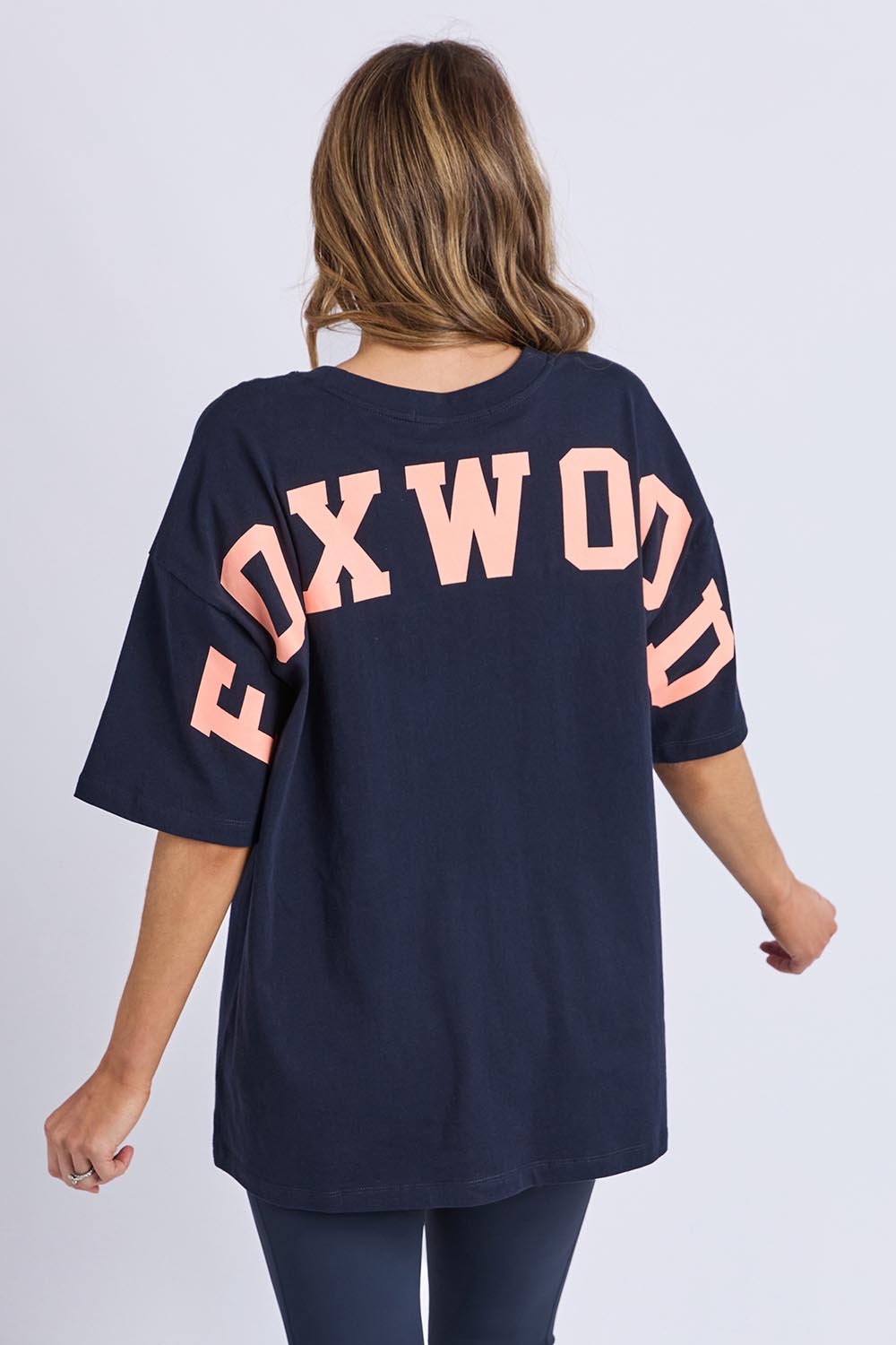 A model wearing the Interval Cotton Tee in colour Navy (Blue), from the back