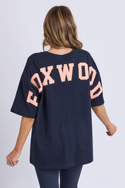 A model wearing the Interval Cotton Tee in colour Navy (Blue), from the back