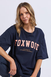 A model wearing the Interval Cotton Tee in colour Navy (Blue), from the front, cropped image