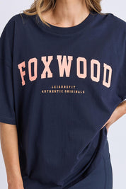 A model wearing the Interval Cotton Tee in colour Navy (Blue), from the front, cropped image