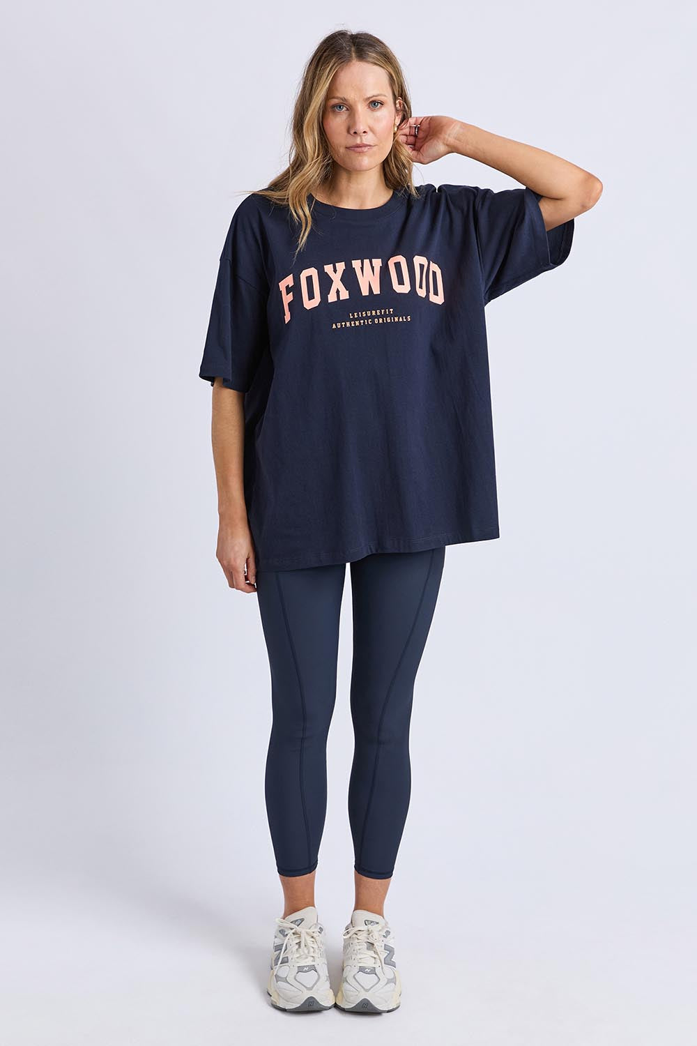 A model wearing the Interval Cotton Tee in colour Navy (Blue), from the front, showing the whole outfit