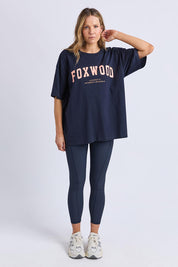 A model wearing the Interval Cotton Tee in colour Navy (Blue), from the front, showing the whole outfit